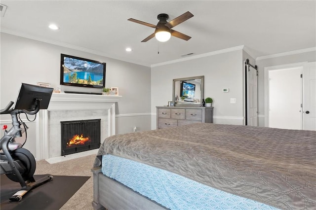 carpeted bedroom with crown molding, a barn door, and ceiling fan