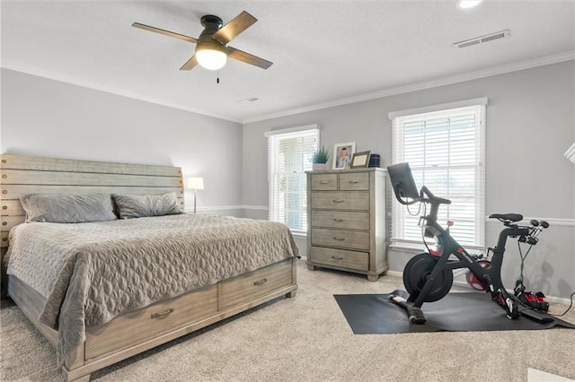 bedroom featuring crown molding, light carpet, and ceiling fan