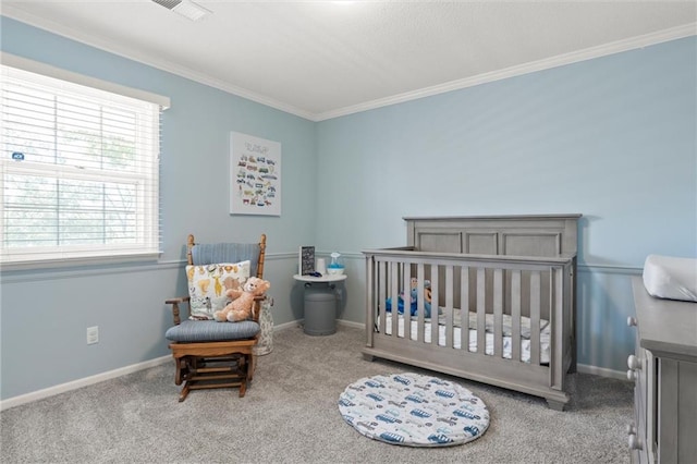 bedroom featuring ornamental molding, carpet floors, and a crib