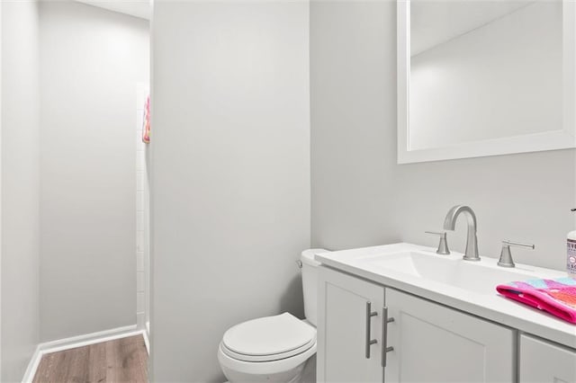 bathroom with vanity, hardwood / wood-style floors, and toilet