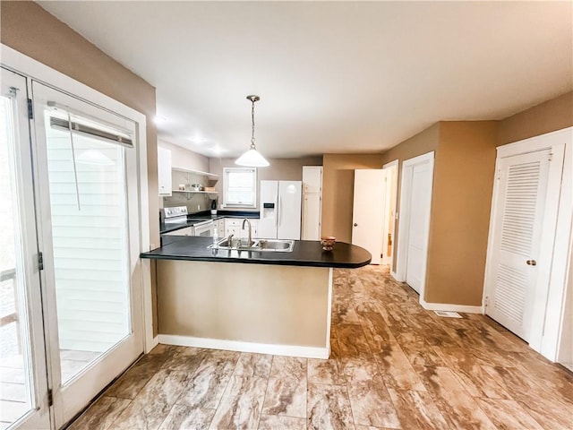 kitchen featuring white appliances, sink, kitchen peninsula, white cabinetry, and pendant lighting