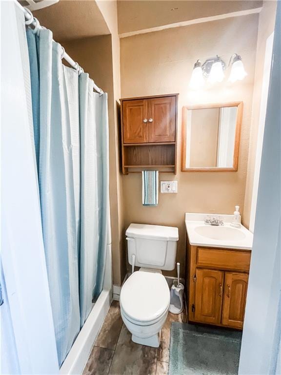 bathroom with vanity, toilet, and walk in shower