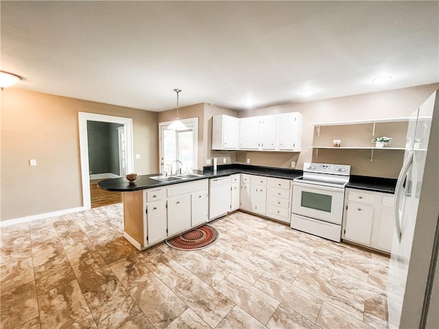 kitchen featuring white appliances, white cabinetry, sink, and kitchen peninsula