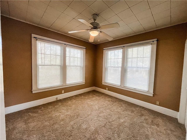 spare room featuring carpet flooring and ceiling fan