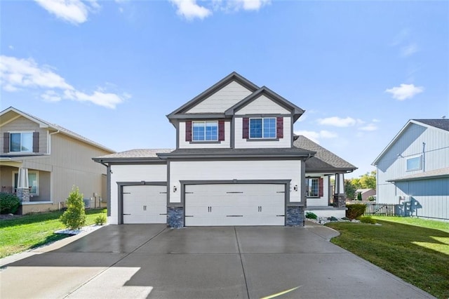 craftsman house featuring a front yard and a garage