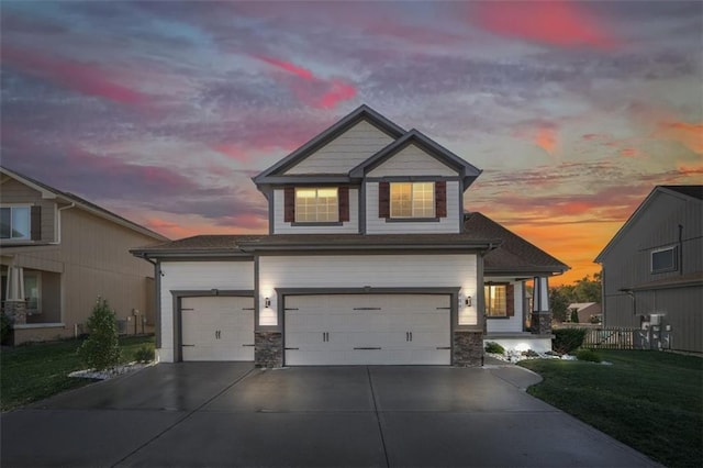 craftsman inspired home with a yard and a garage