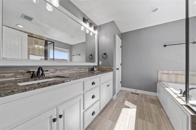 bathroom featuring vanity, tasteful backsplash, tile patterned floors, and separate shower and tub