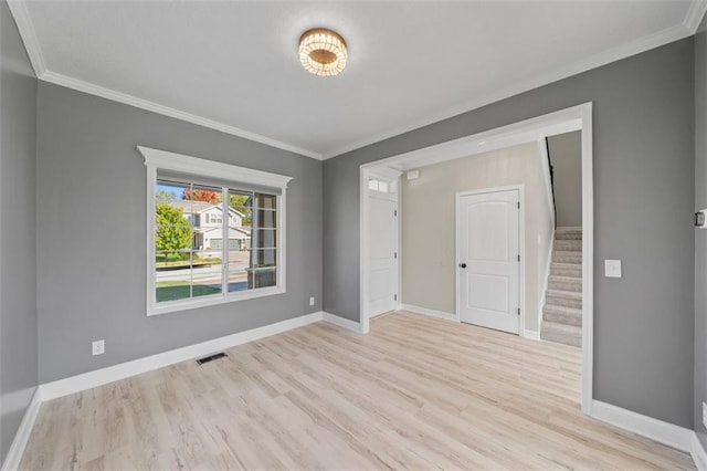 unfurnished room featuring light hardwood / wood-style flooring and ornamental molding