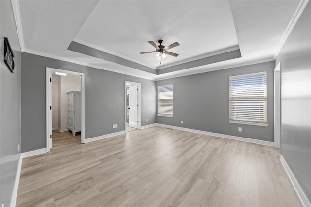 unfurnished bedroom featuring light hardwood / wood-style flooring, multiple windows, and ceiling fan