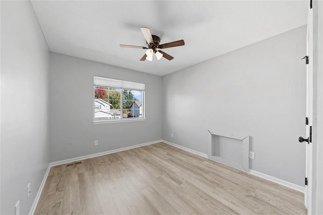 spare room with ceiling fan and light wood-type flooring