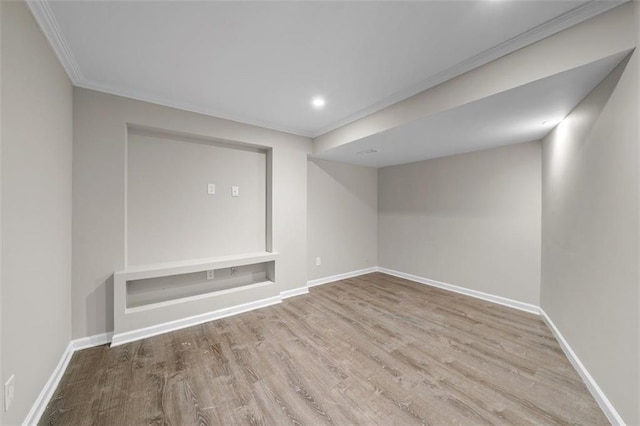 basement featuring light hardwood / wood-style floors and ornamental molding