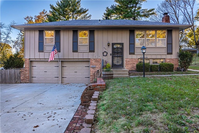 split foyer home with a garage and a front yard