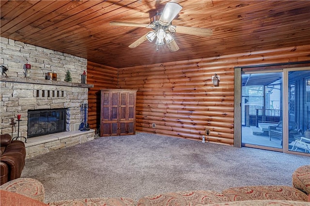 unfurnished living room featuring a stone fireplace, rustic walls, carpet flooring, and wooden ceiling