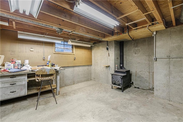 basement featuring a workshop area and a wood stove