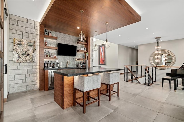 bar with pendant lighting, wooden ceiling, sink, and a chandelier