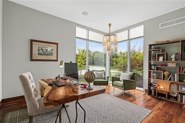 office featuring hardwood / wood-style flooring, a notable chandelier, and floor to ceiling windows