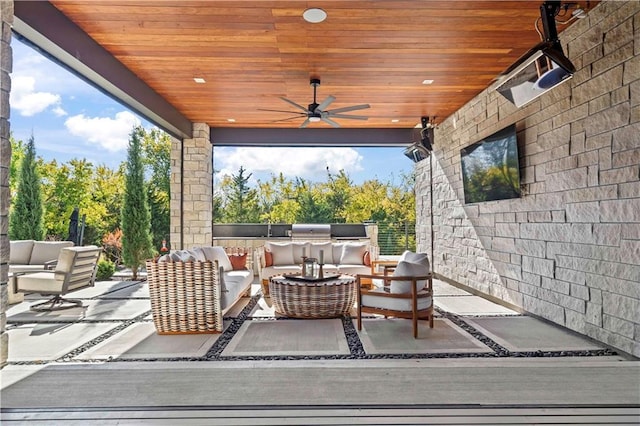 view of patio / terrace featuring an outdoor living space, ceiling fan, and an outdoor kitchen