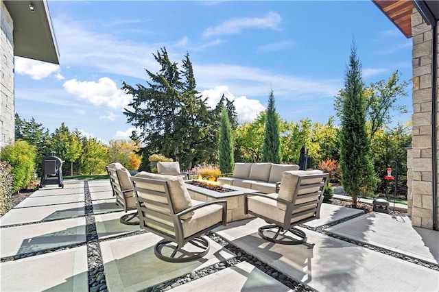 view of patio / terrace featuring an outdoor living space with a fire pit