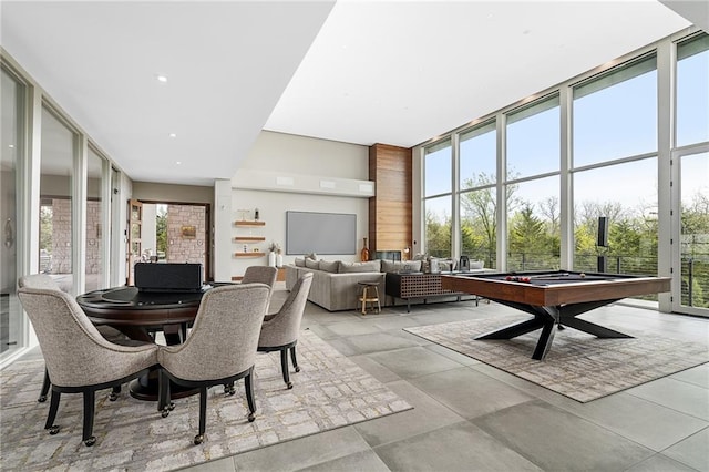 interior space featuring plenty of natural light, a wall of windows, and pool table