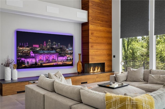 home theater room featuring wooden walls and a fireplace