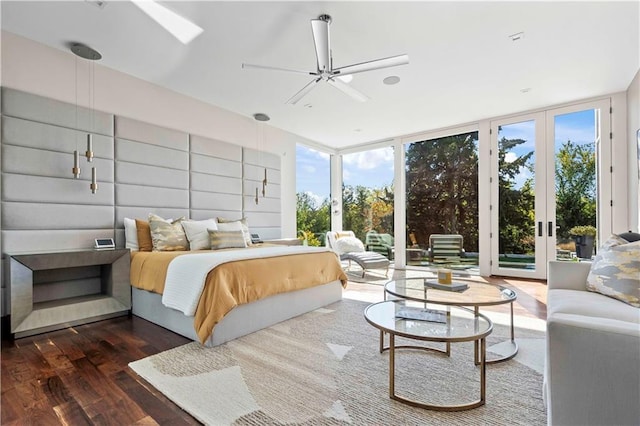 bedroom with ceiling fan, dark hardwood / wood-style flooring, access to outside, and multiple windows