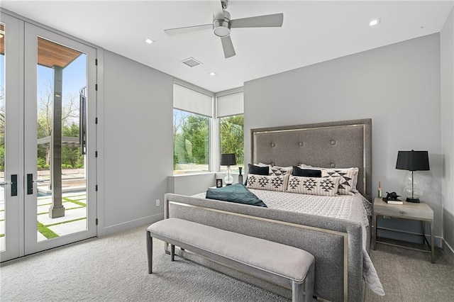 carpeted bedroom featuring multiple windows, access to exterior, french doors, and ceiling fan