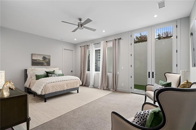 bedroom with multiple windows, access to outside, light carpet, and french doors