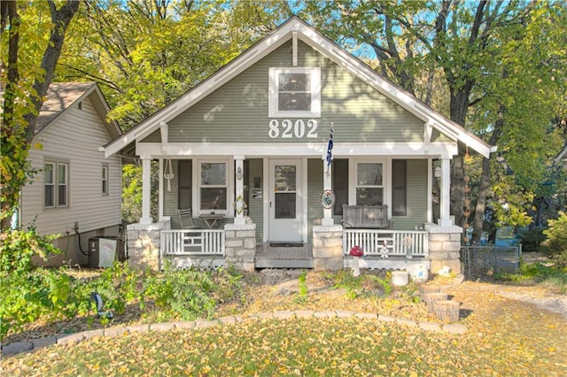 bungalow-style home with central air condition unit and a porch