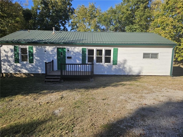 ranch-style home with a front yard and a deck