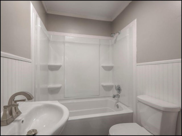 full bathroom with sink, bathtub / shower combination, and toilet