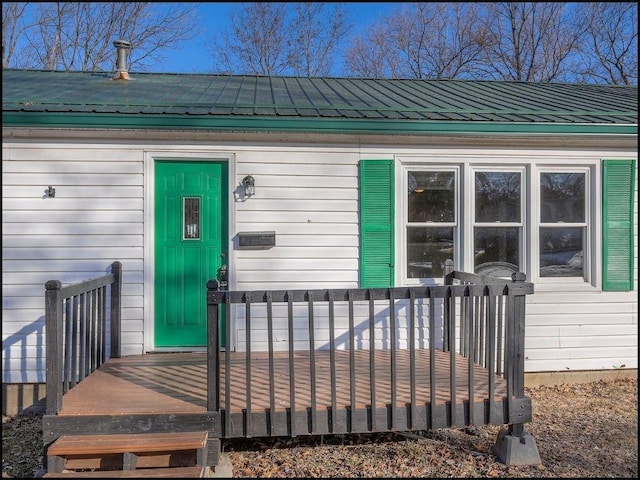 property entrance with a deck