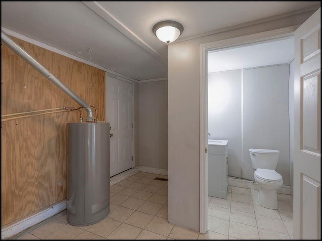 interior space with vanity, tile patterned floors, water heater, and toilet