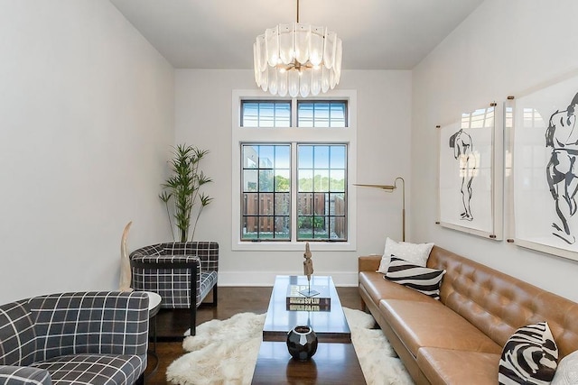 living room with dark wood-type flooring and a chandelier