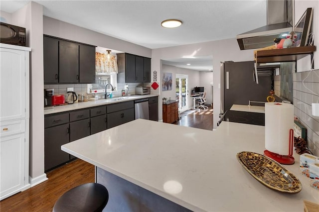 kitchen featuring black appliances, sink, backsplash, and exhaust hood