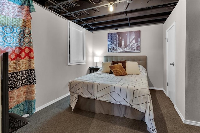 bedroom with dark colored carpet and beam ceiling