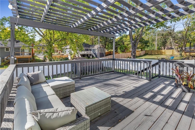 wooden deck with an outdoor living space and a pergola