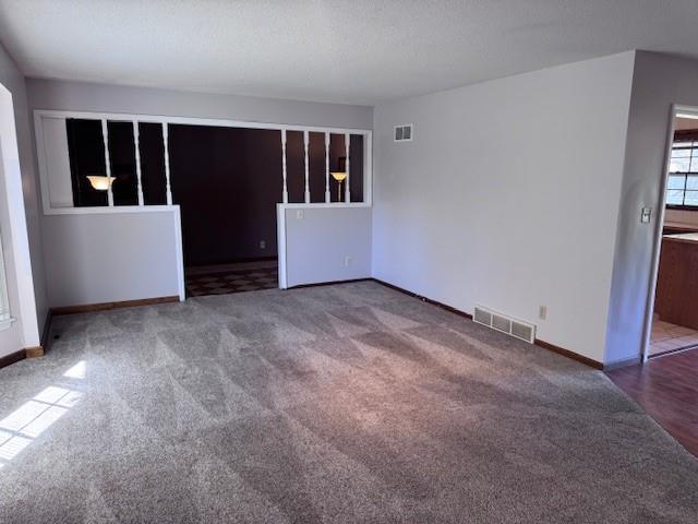 unfurnished room featuring carpet