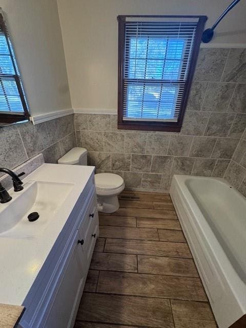 full bathroom with vanity, toilet, and  shower combination