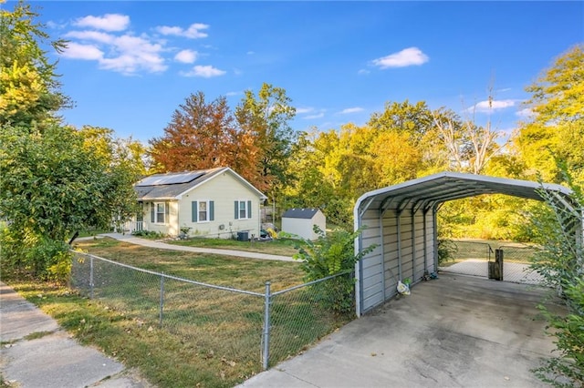 view of front of property with a carport, a front lawn, and solar panels