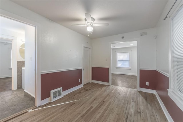 empty room featuring light hardwood / wood-style floors and ceiling fan