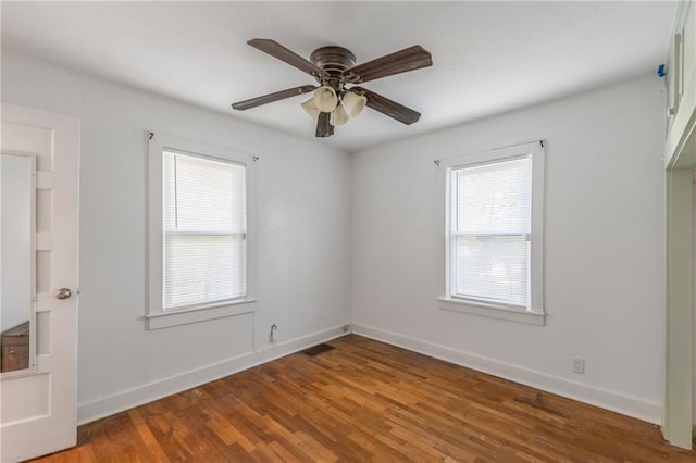 spare room featuring hardwood / wood-style floors and ceiling fan