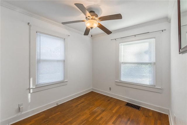 empty room featuring crown molding, dark hardwood / wood-style flooring, and ceiling fan