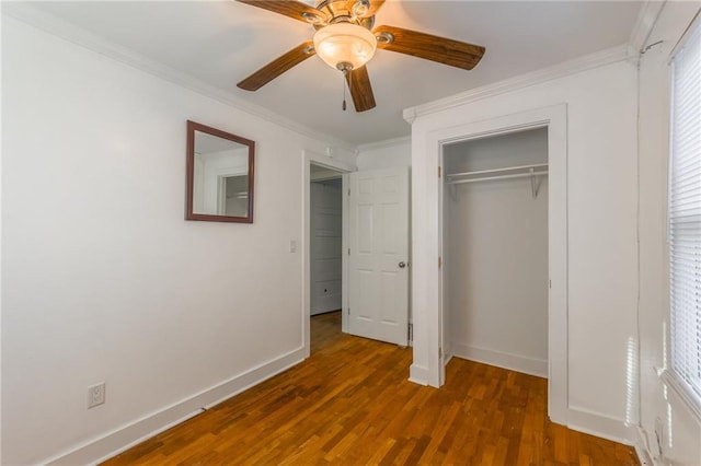 unfurnished bedroom with dark hardwood / wood-style flooring, crown molding, and ceiling fan