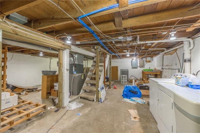 basement featuring electric panel and washing machine and dryer