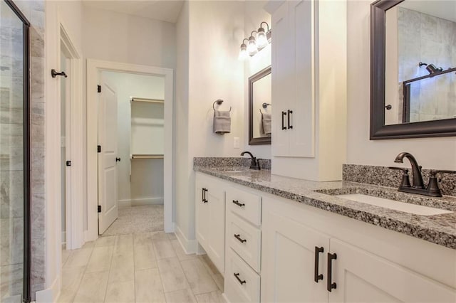 bathroom with vanity and a shower with shower door