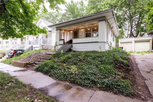 view of front of home featuring covered porch and a garage