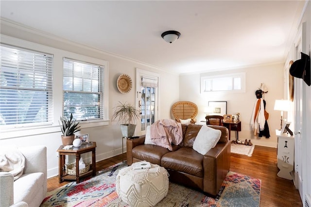 living room featuring ornamental molding, dark wood-type flooring, and plenty of natural light