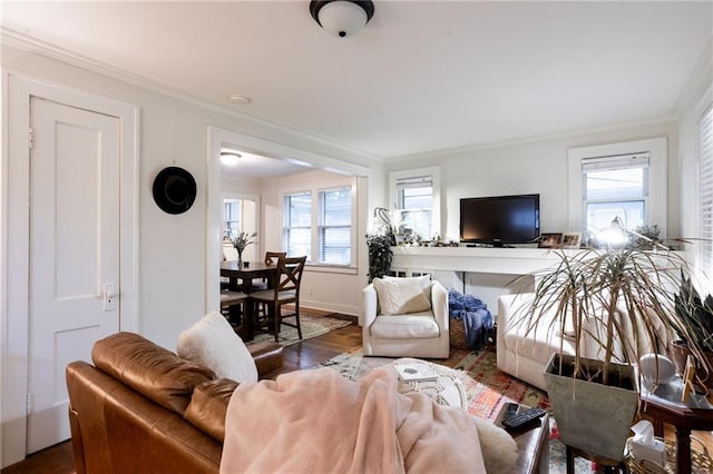 living room featuring crown molding, dark hardwood / wood-style floors, and a healthy amount of sunlight