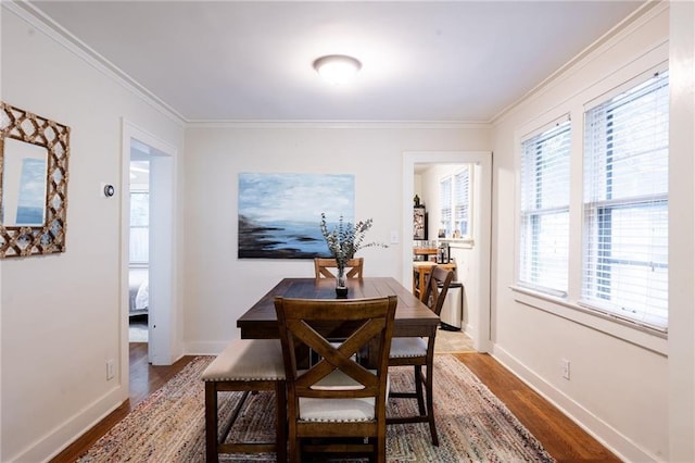 dining area featuring ornamental molding and hardwood / wood-style floors