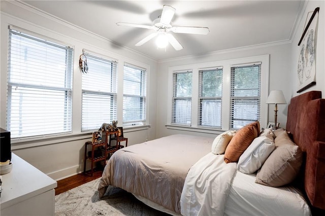 bedroom featuring ornamental molding, hardwood / wood-style floors, and ceiling fan